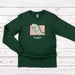 a green long sleeve shirt with a dinosaur on it