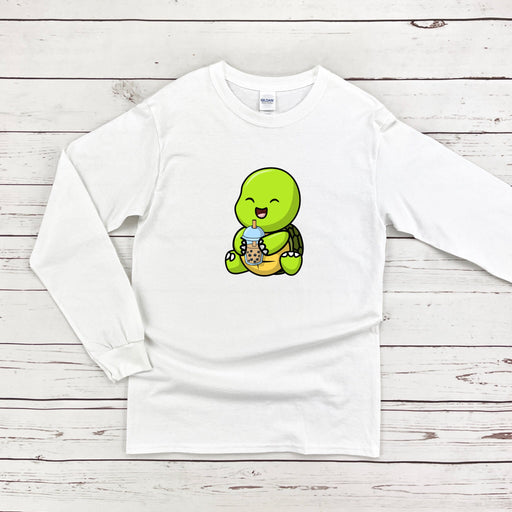 a white shirt with a green turtle eating a banana