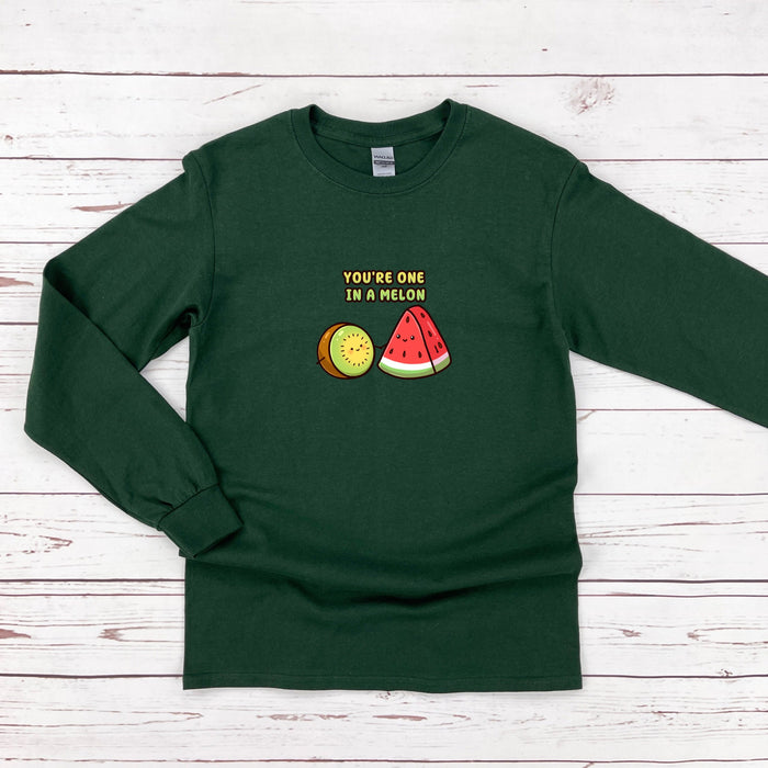 a green shirt with a watermelon and tennis ball on it