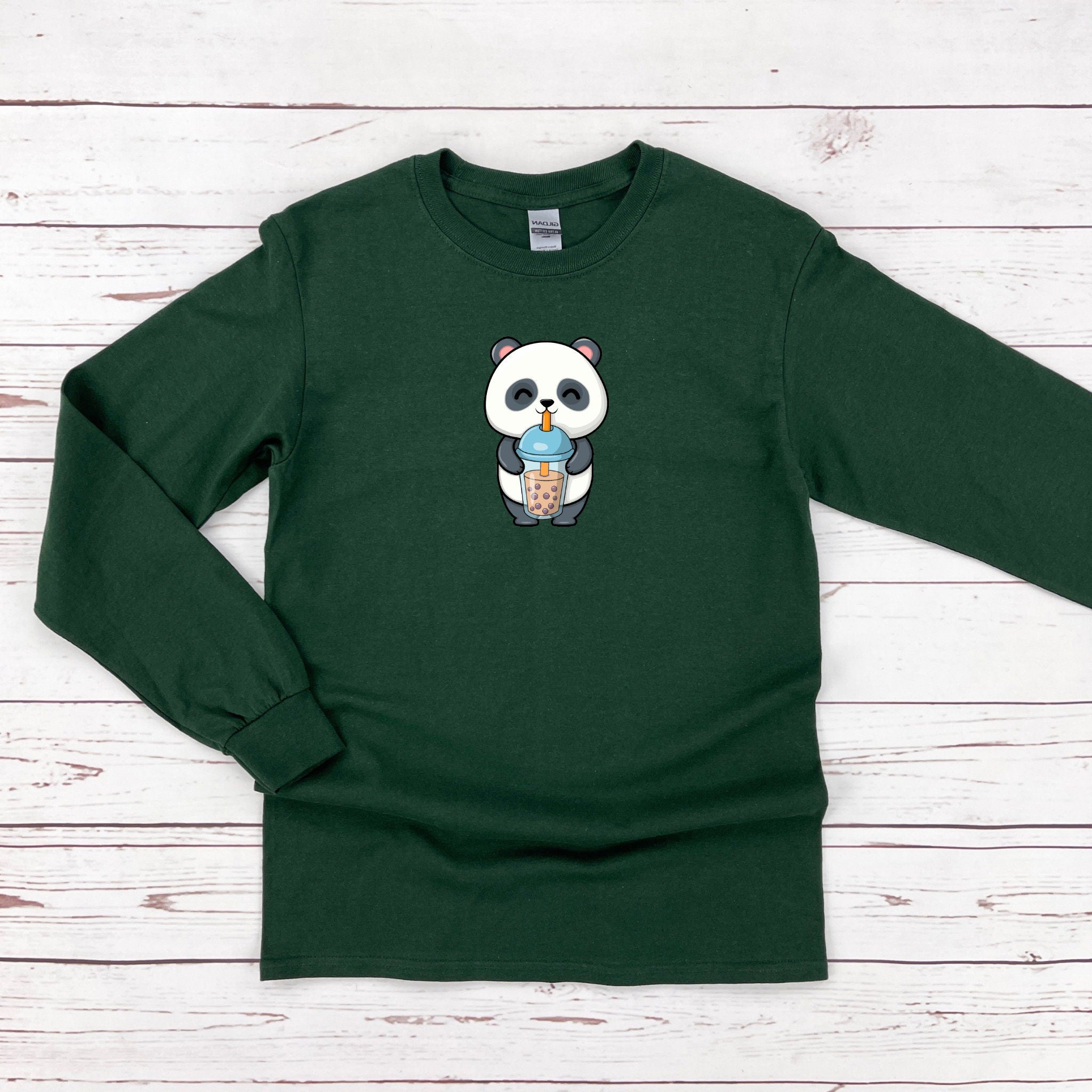 a green shirt with a panda eating an ice cream cone