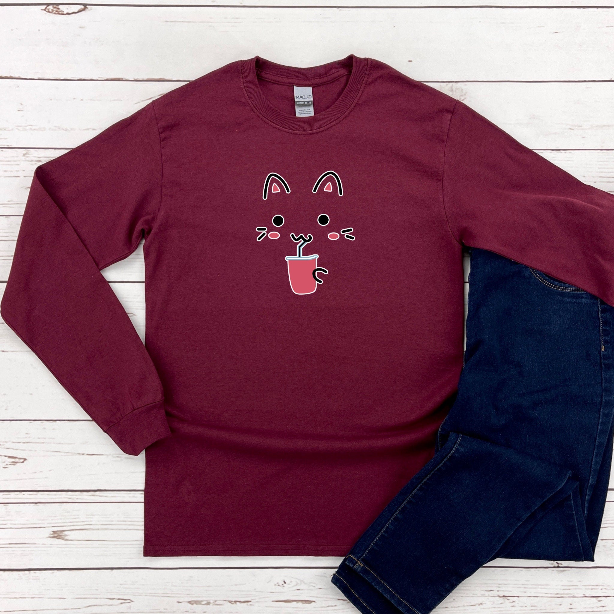 a red shirt with a cat face on it