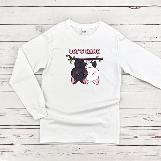 a white long - sleeved shirt with a dog and cat on it