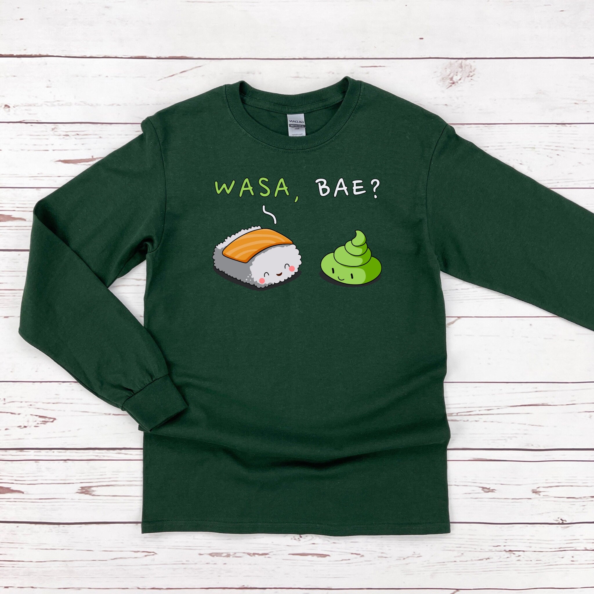 a green tshirt with sushi on it that says wasa bae?
