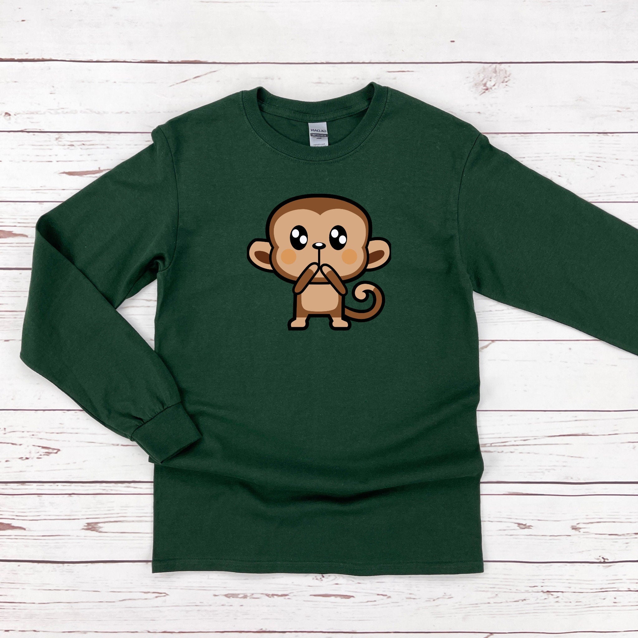 a green shirt with a cartoon monkey on it