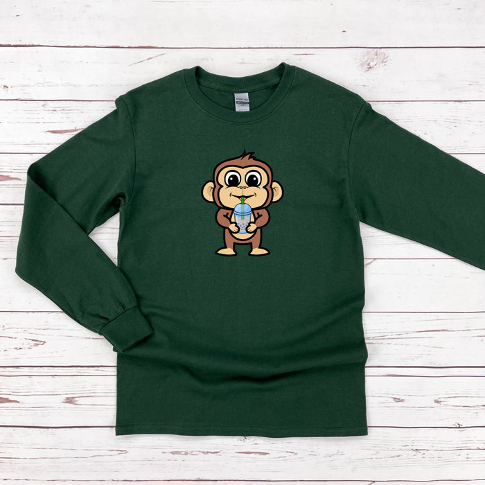 a green shirt with a cartoon monkey holding a ball