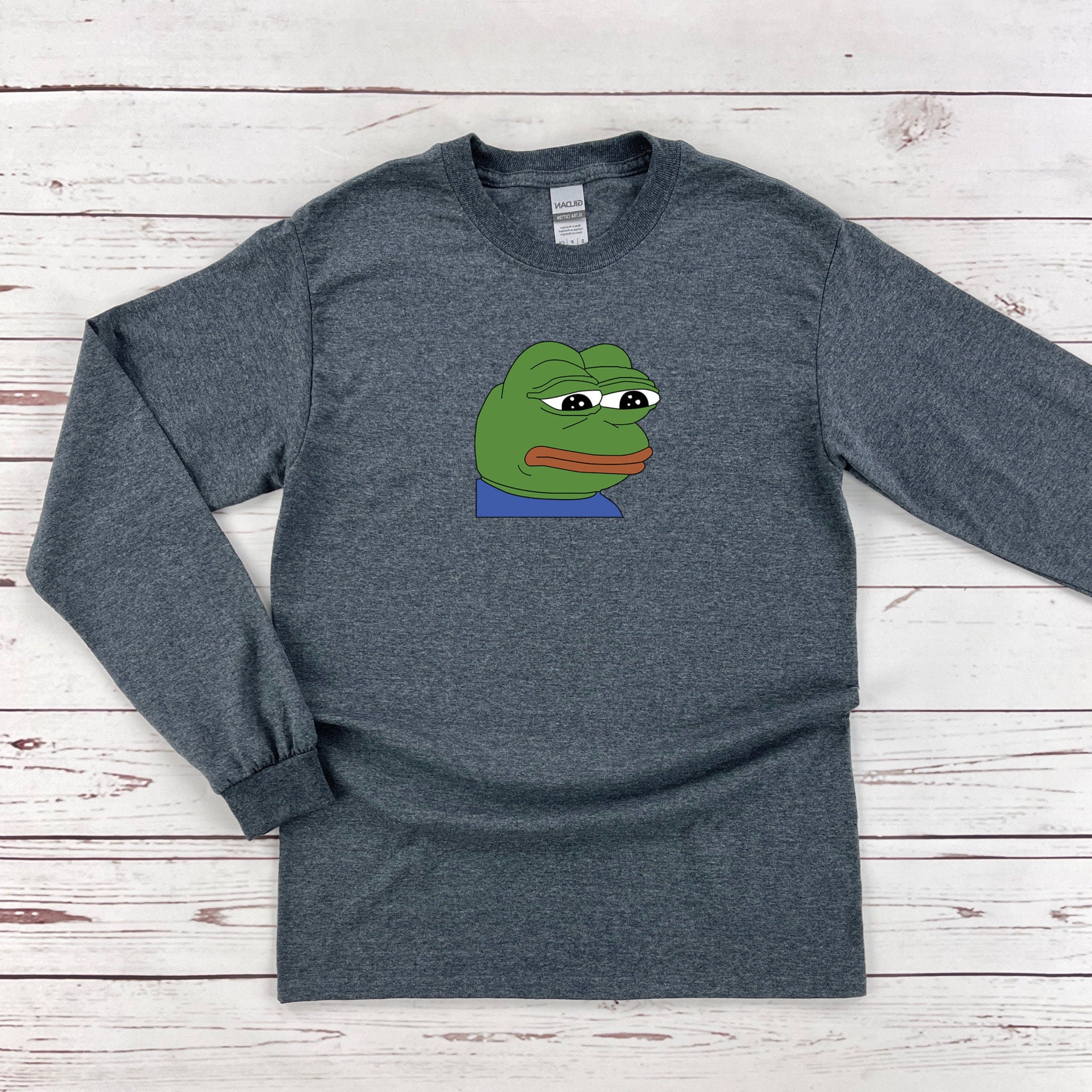 a gray shirt with a green frog on it