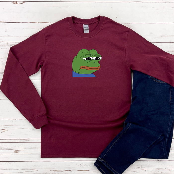 a red shirt with a green frog on it