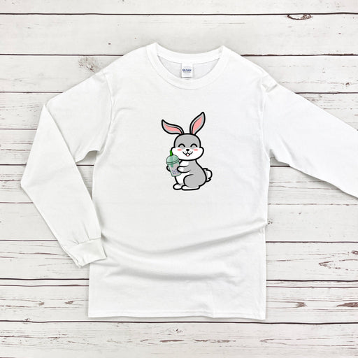 a white shirt with a bunny holding a carrot