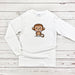 a white shirt with a cartoon monkey on it