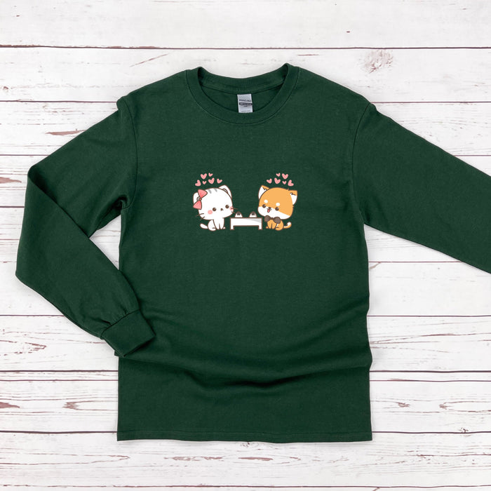 a green shirt with two cats on it