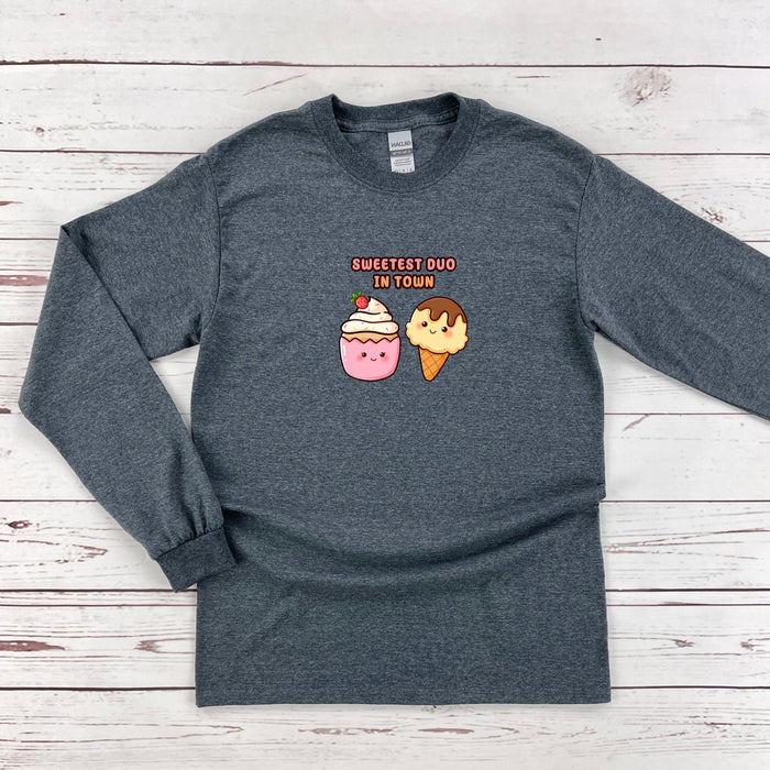 a long sleeved shirt with an image of two donuts and a cupcake