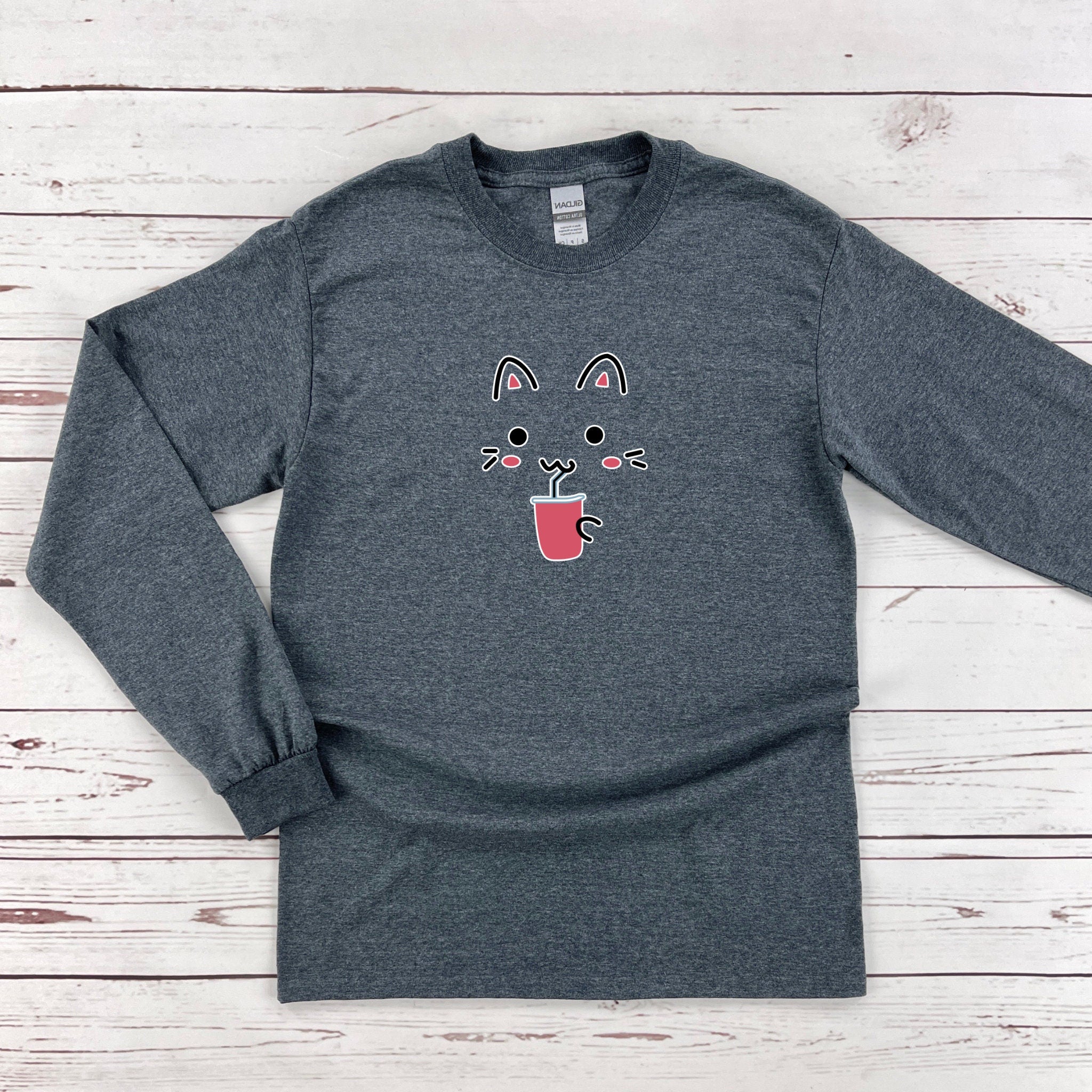 a gray shirt with a cat face on it