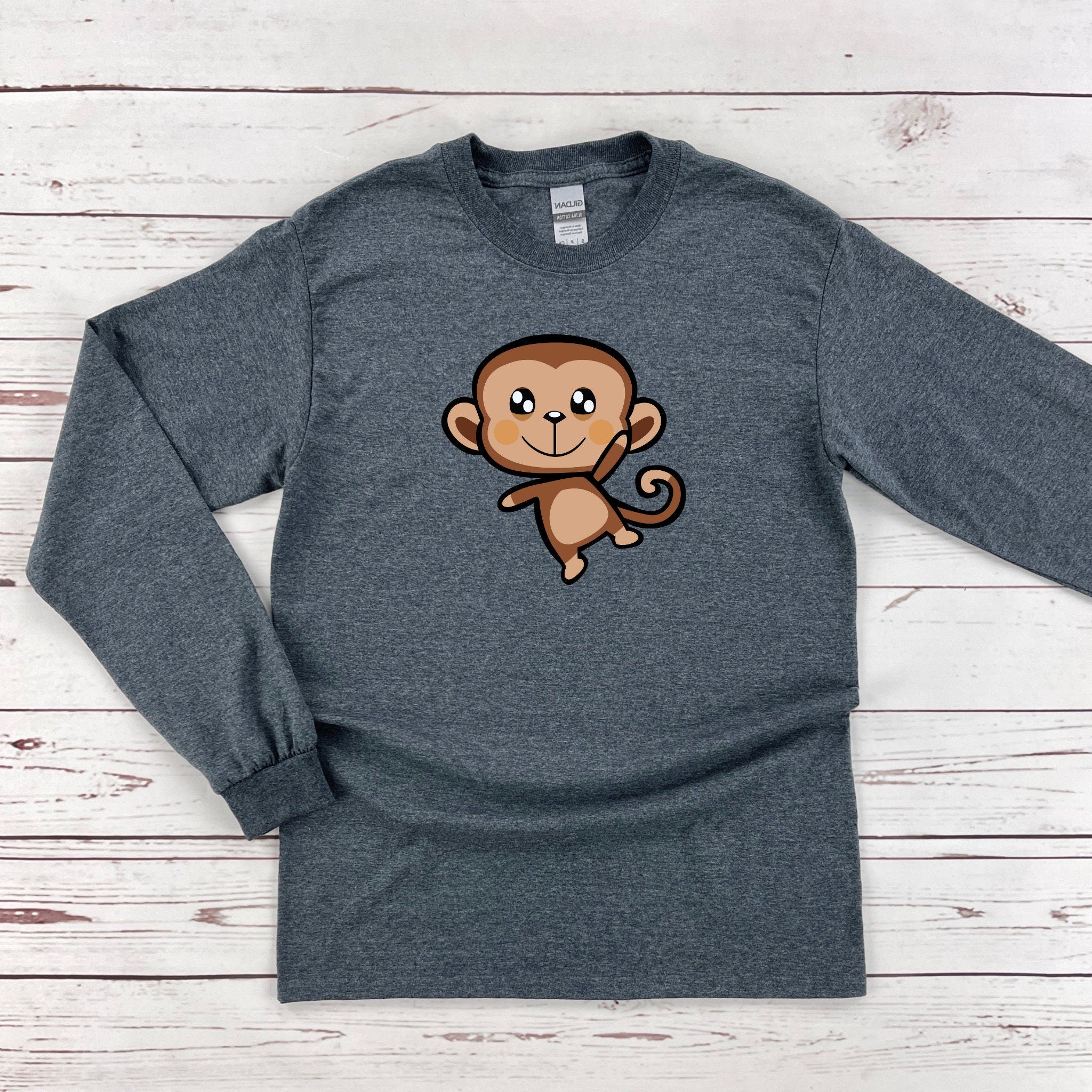 a gray shirt with a cartoon monkey on it