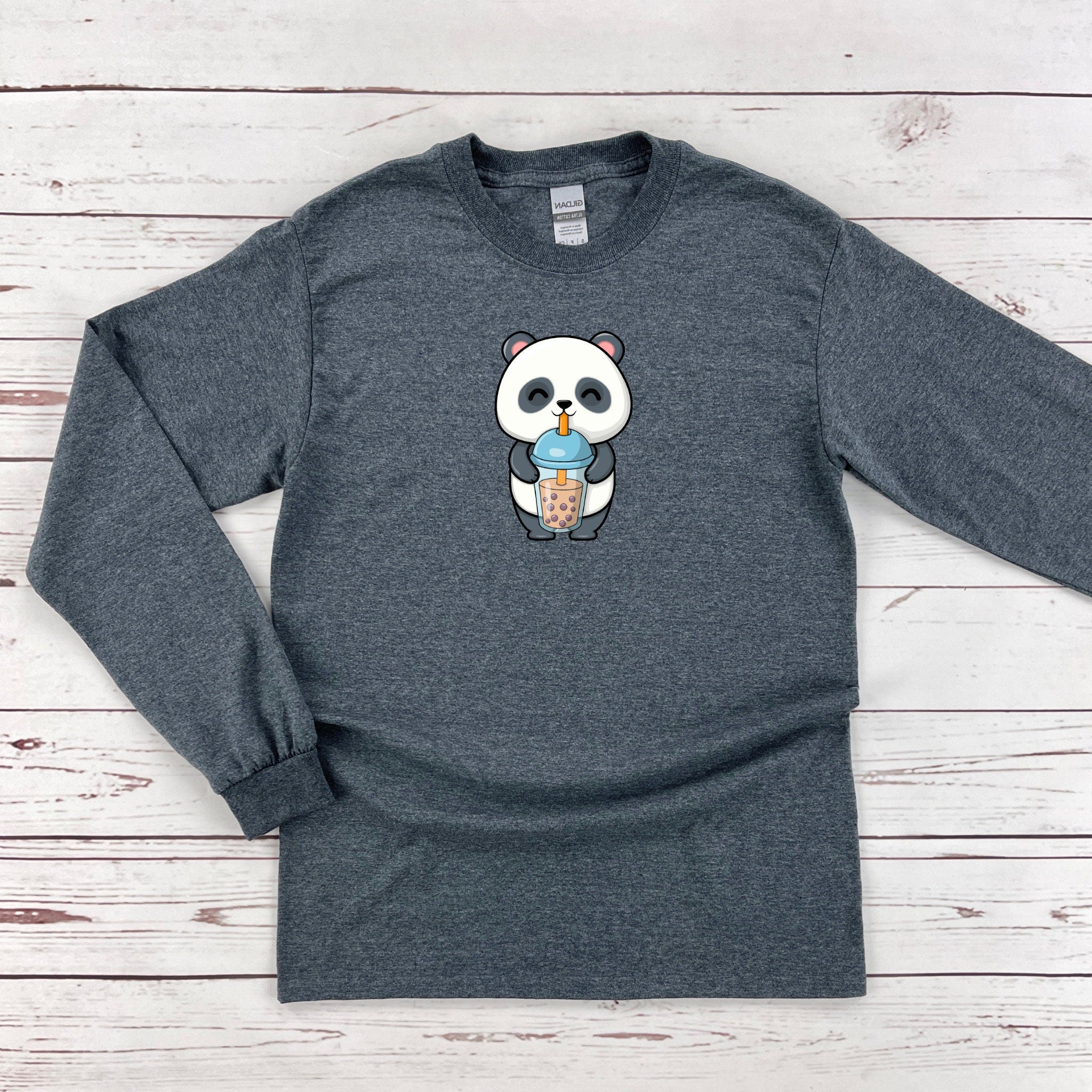 a long sleeved shirt with a panda eating a cup of coffee
