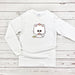 a white shirt with a cat on it