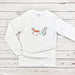 a white long sleeved shirt with a coffee cup and donuts on it