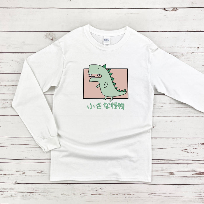 a white t - shirt with a green dinosaur on it