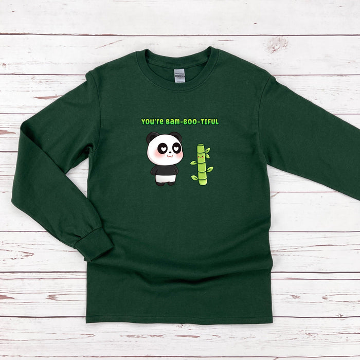 a green shirt with a panda holding a cactus