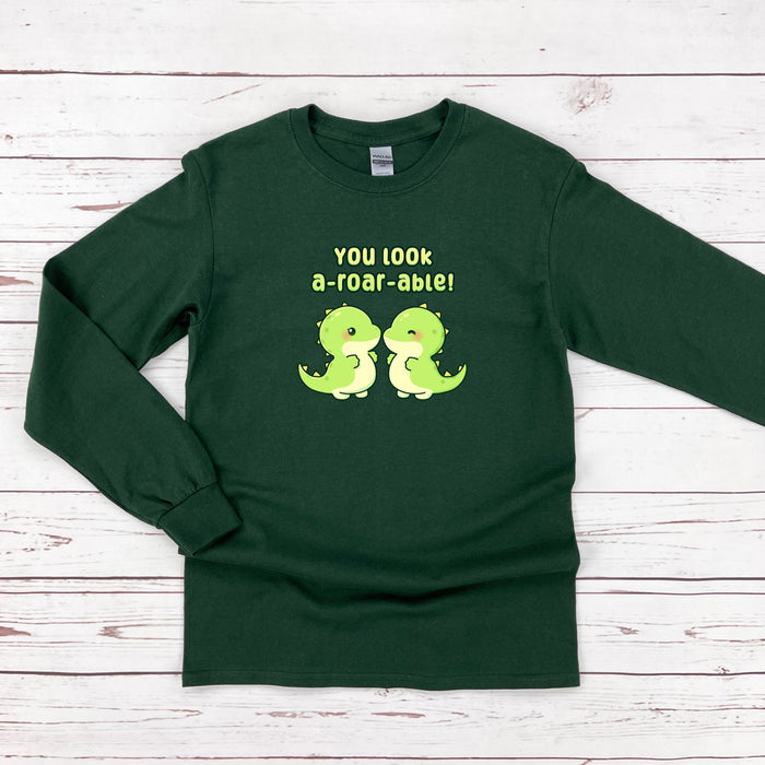a green t - shirt with two green dinosaurs on it