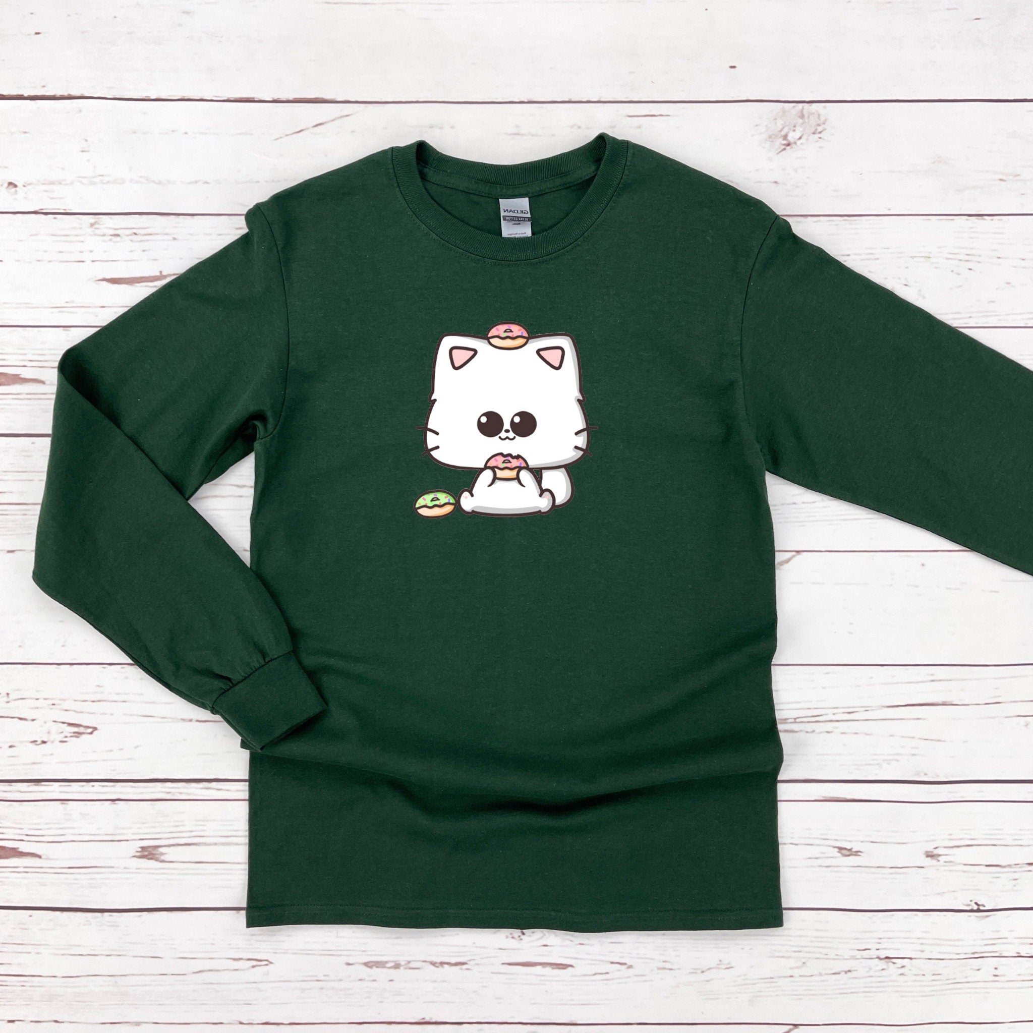 a green shirt with a white cat on it