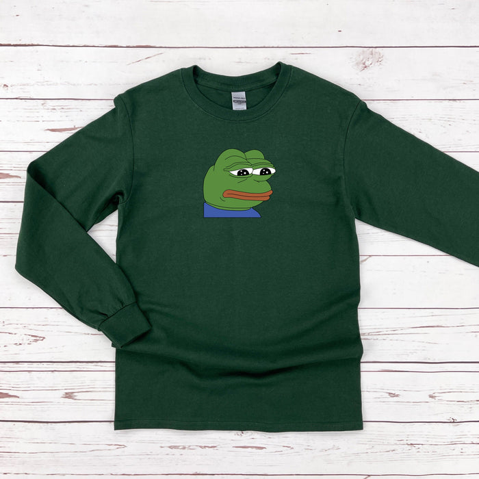 a green shirt with a cartoon frog on it