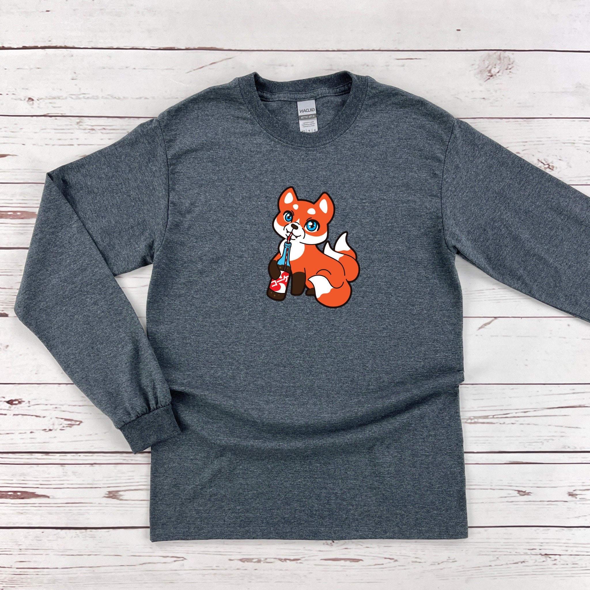 a gray long sleeve shirt with a cartoon fox on it