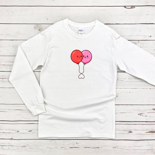 a white long sleeve shirt with two balloons on it