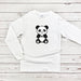 a white shirt with a black and white panda bear on it