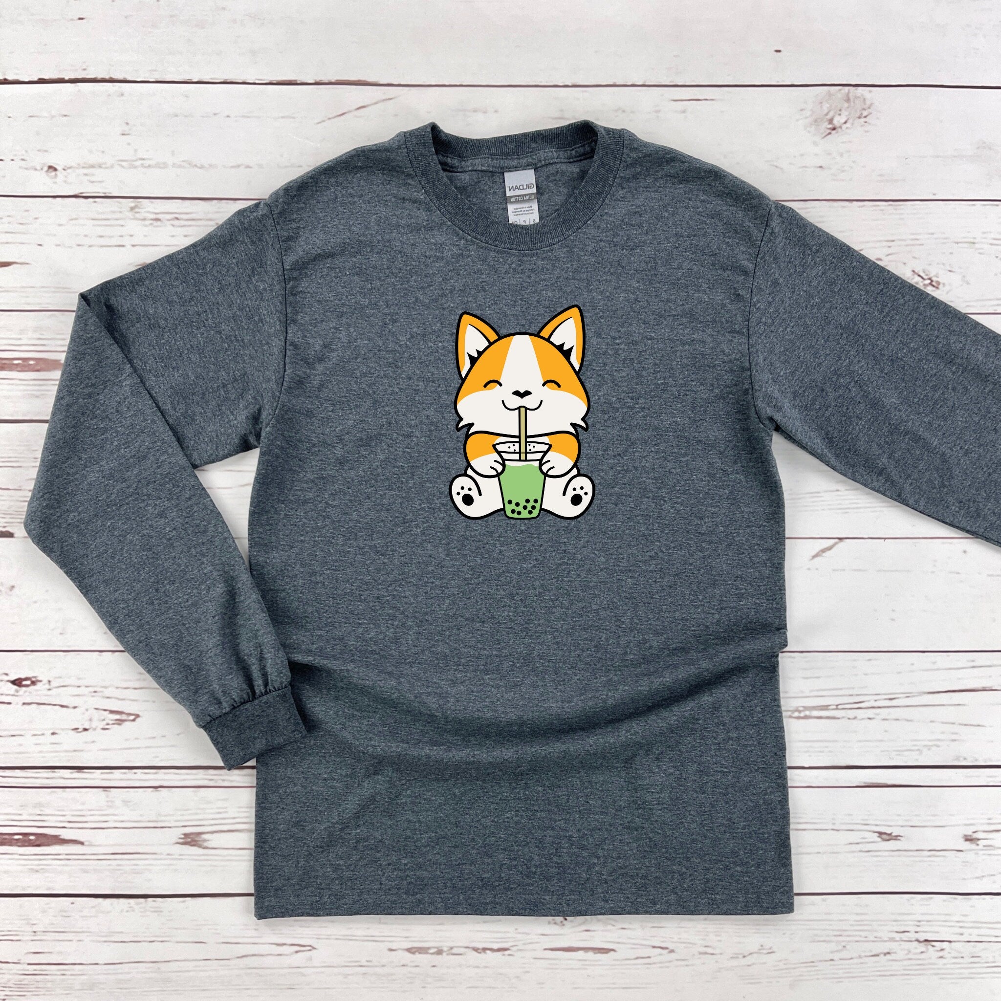 a gray long sleeve shirt with a cartoon cat on it
