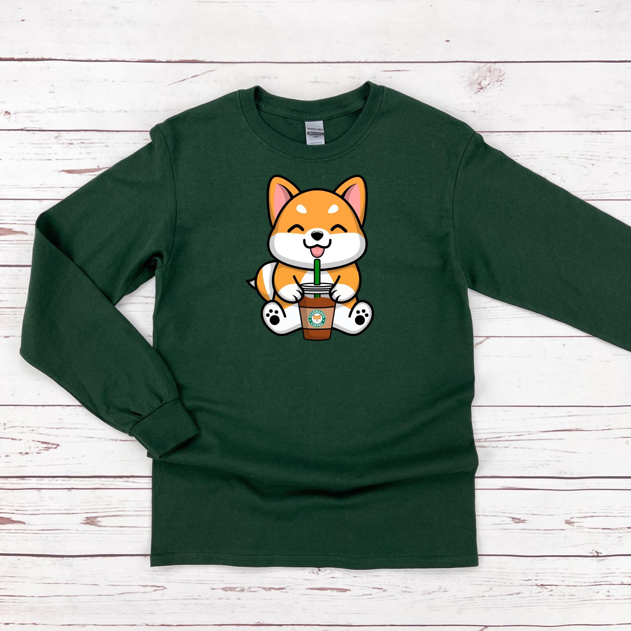 a green shirt with a cartoon fox holding a cup of coffee