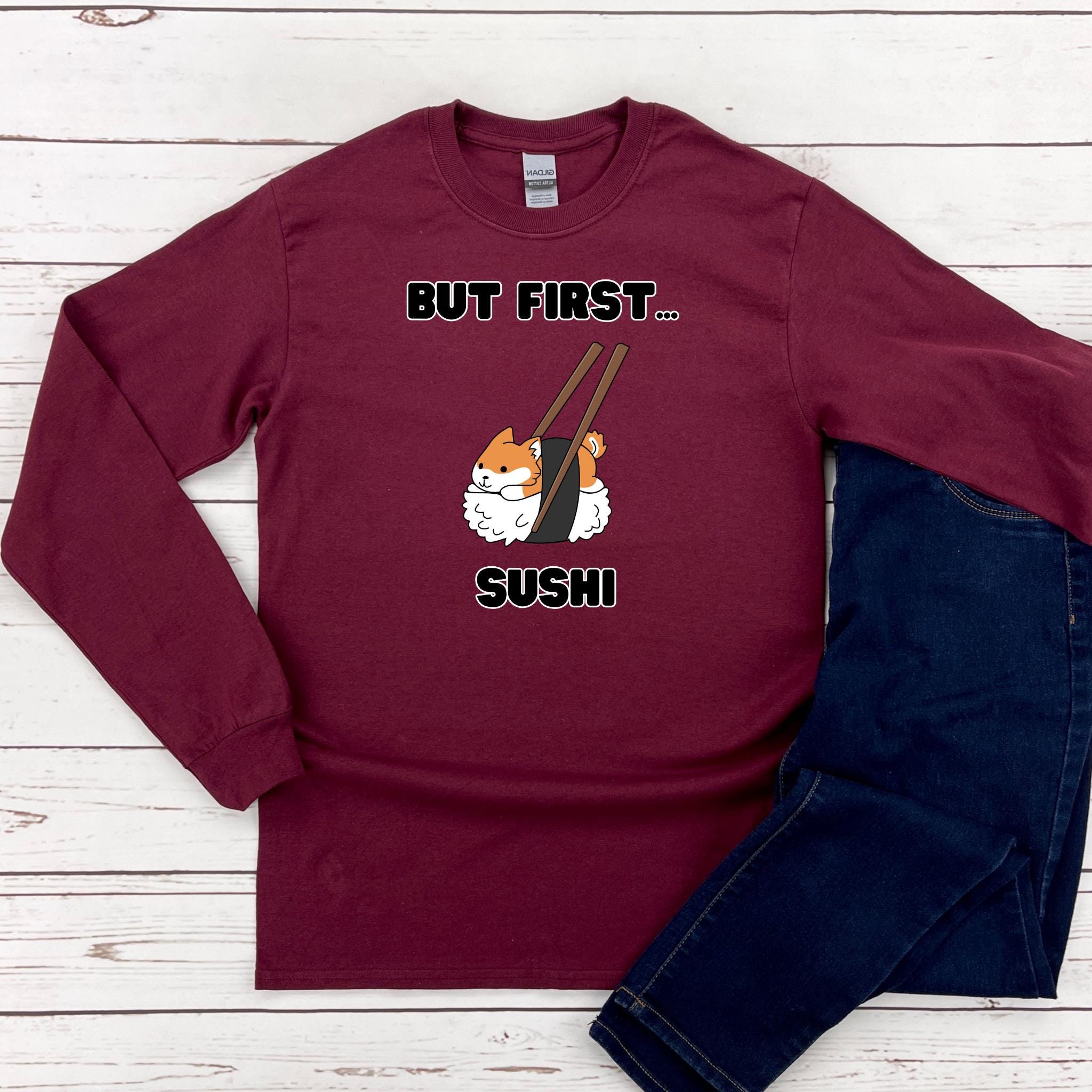 a red shirt that says but first, sushi