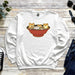 a sweatshirt with three cats in a bowl on it