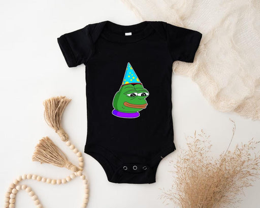 a baby bodysuit with a cartoon of a frog wearing a party hat