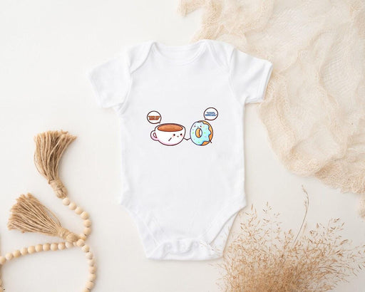a baby bodysuit with a picture of a coffee cup and a donut
