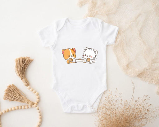 a baby bodysuit with a picture of a dog and a cat on it