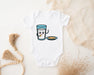 a baby bodysuit with a picture of a glass of milk and a plate of