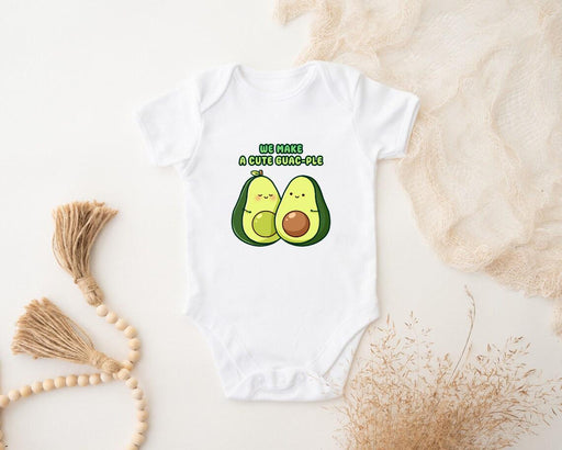 a baby bodysuit with two avocados on it