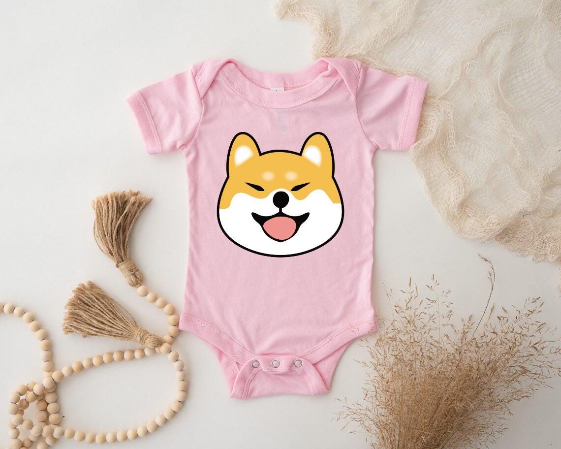 a pink baby bodysuit with a dog's face on it