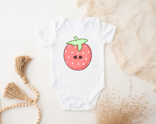 a white bodysuit with a strawberry on it