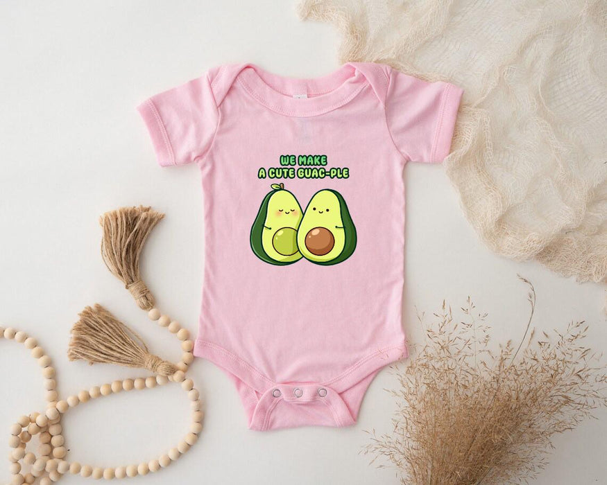 a pink baby bodysuit with two avocados on it