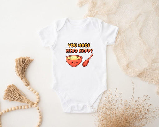 a baby bodysuit with a bowl of cereal on it