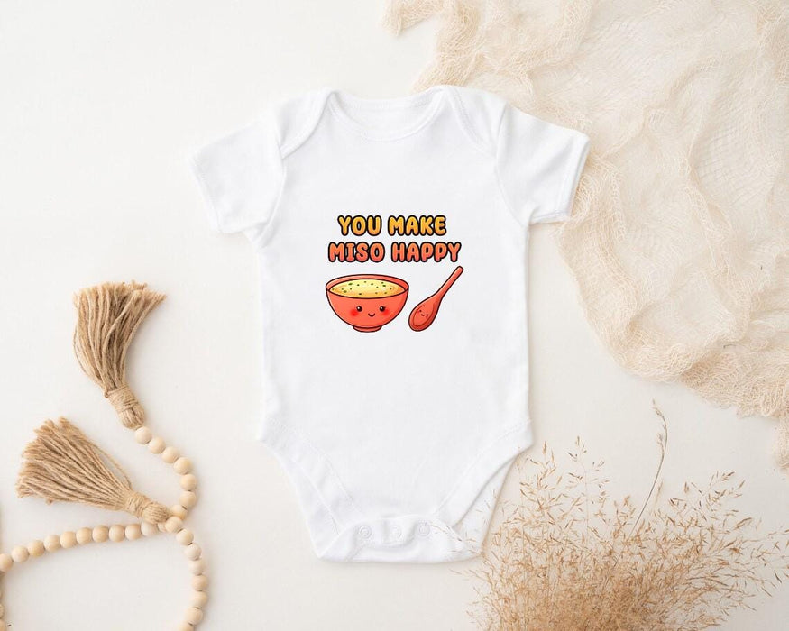 a baby bodysuit with a bowl of cereal on it