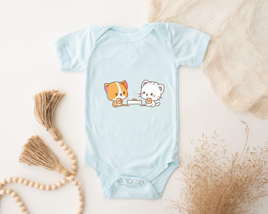 a baby bodysuit with a picture of a cat and a dog on it
