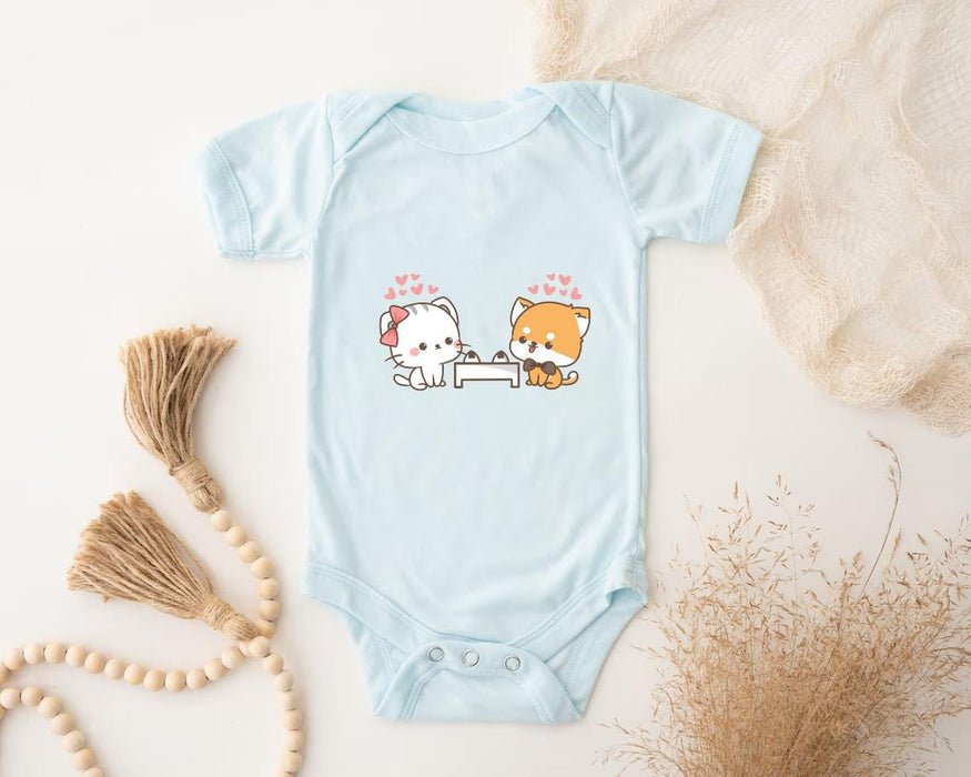 a baby bodysuit with a picture of a cat and a dog on it