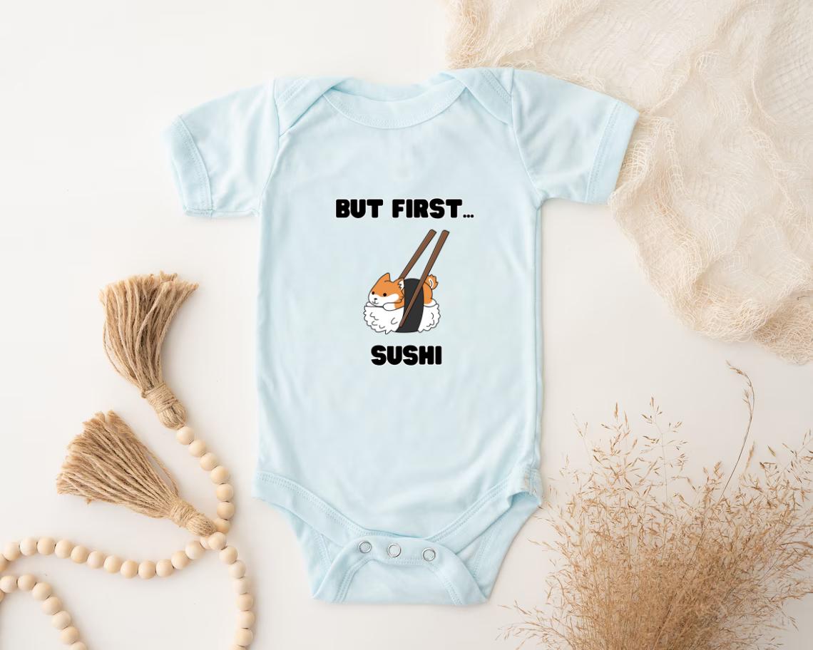 a baby bodysuit that says, but first sushi