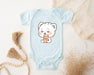 a baby bodysuit with a picture of a bear holding a cup