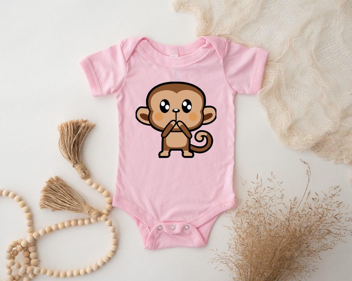 a pink baby bodysuit with a cartoon monkey on it