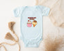 a baby bodysuit with a picture of a cupcake and a strawberry on it