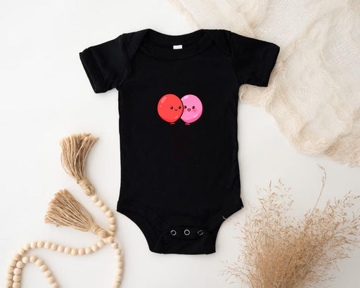 a baby bodysuit with two balloons on it