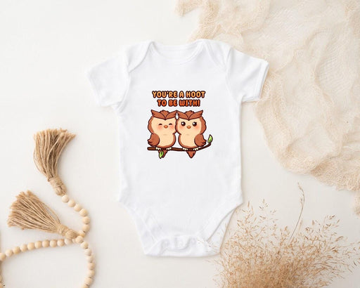 a baby bodysuit with two owls on it